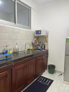 a kitchen with a sink and a counter top at Cozy loft Bonamoussadi Douala in Douala