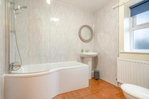 a white bathroom with a tub and a sink at 2 Bed in Escomb oc-o34978 in Acomb +27 photos