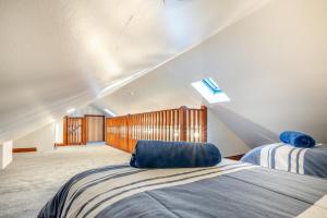a attic bedroom with two beds and a window at 2 Bed in Escomb oc-o34978 in Acomb