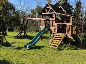 a playground with a slide and a play house at 1 Bed in Bude oc-s34849 in Bude