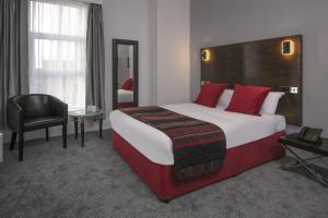 a hotel room with a large bed and a chair at Best Western The Grand Hotel Hartlepool in Hartlepool