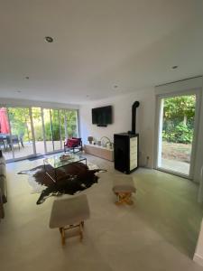 a living room with a table and a fireplace at Lapacy Hardelot in Neufchâtel-Hardelot