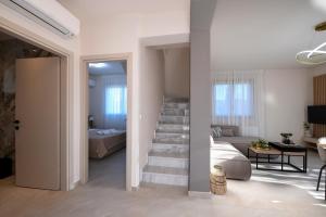 a living room with a staircase leading to a bedroom at Golden Gaia Villas in Kipía +33 photos