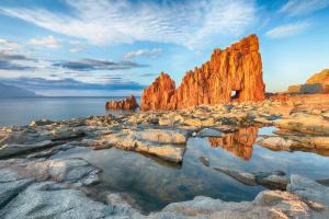 a rock formation on the shore of a body of water at Skyline Balcony in Loceri
