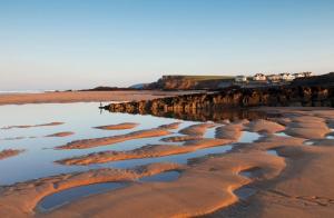 a beach with rocks and water in the sand at 1 Bed in Bude oc-s34847 in Bude