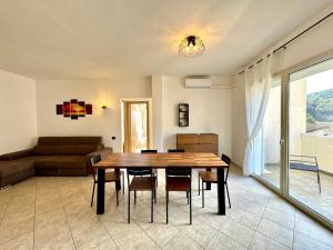 a living room with a table and a couch at Skyline Balcony in Loceri +20 photos