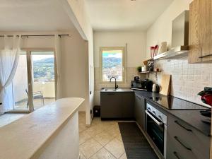 a kitchen with a sink and a counter top at Skyline Balcony in Loceri