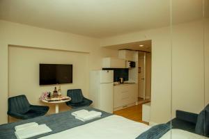 a bedroom with a bed and a table with chairs at Orbi HighView Panoram Hotel in Batumi