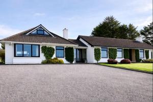 a house with a large driveway in front of it at Derrynane Bay House in Caherdaniel