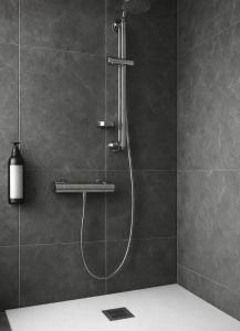a shower with a shower head in a bathroom at Derrynane Bay House in Caherdaniel