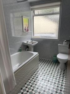 a bathroom with a tub and a sink and a toilet at Crianlarich Cottage in Fort Augustus