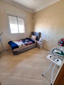 a bedroom with a bed and a table in it at Apartmen rentals with M Z in Marrakesh
