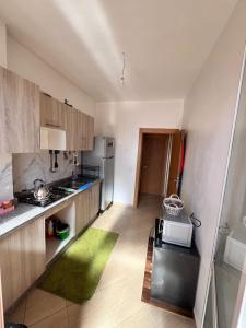 a small kitchen with a sink and a refrigerator at Apartmen rentals with M Z in Marrakesh