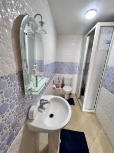 a blue and white bathroom with a sink and a toilet at Apartmen rentals with M Z in Marrakesh