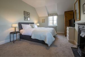 a bedroom with a large bed and a television at Green Balk Cottage in Stokesley