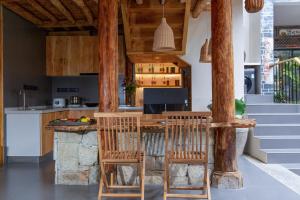 a kitchen with a bar with wooden stools at 心墅 空间 in Dali