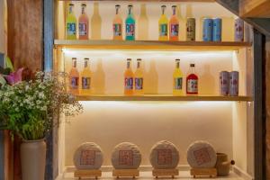 a display of wine bottles in a display case at 心墅 空间 in Dali +25 photos