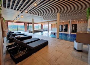 a living room with a pool and some chairs at L'ORIGINE in Saint-Aubin +25 photos