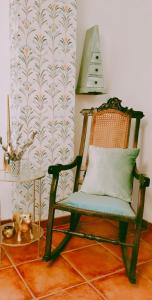 a chair with a pillow on it in a room at Todos Y Tonya in Archidona