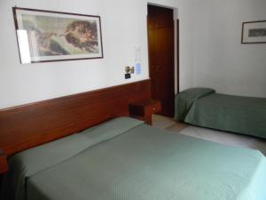 Postel nebo postele na pokoji v ubytování Hotel Primavera