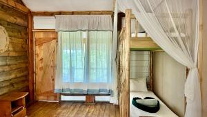 a bedroom with two bunk beds and a window at Miseni Retreat in Bagamoyo
