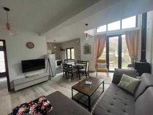 a living room with a couch and a table at Ćilibar Stara planina in Crni Vrh