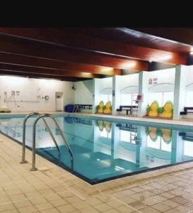 a large swimming pool in a building at Jasper Lodge in Morecambe