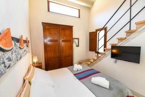 a room with a bed and a tv and stairs at Locanda Sette Fate SPA e Solarium in Palermo +63 photos