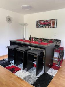 a room with a table with stools and a couch at Klein und Fein in Hartberg