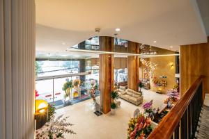 a lobby of a building with flowers and plants at Elegance Ninh Binh Hotel in Kỳ Vĩ