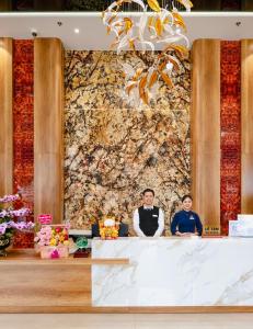 two men sitting at a table in front of a wall at Elegance Ninh Binh Hotel in Kỳ Vĩ +57 photos