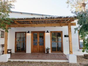a pergola over a porch of a house at OLYF accommodation in Bloemfontein +4 photos