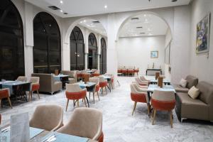 a dining room with tables and chairs and tablesktop at Royal Mirage Deluxe in Marrakesh
