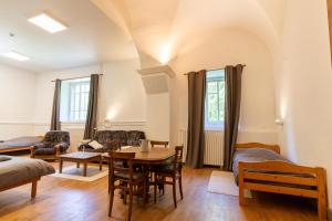 a living room with a table and a couch at Monastère du Val de Consolation in Consolation-Maisonnettes
