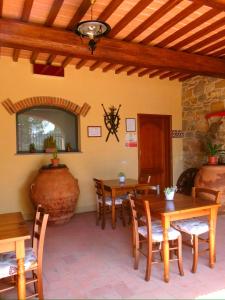 a dining room with wooden tables and chairs at Agriturismo IL VIAIO in Fiesole