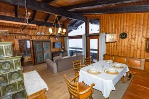 a dining room with a table and a couch at Apartment Schönblick in Verditz