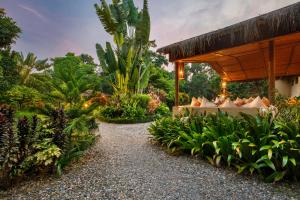 a garden with a table and some plants at Green Mansions Jungle Resort in Sauraha