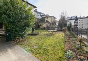 a yard with a tree and a fence at Casa di Montagna tranquilla e spaziosa in Serina