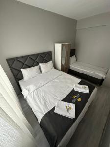 a bedroom with a bed with two towels on it at Zirve Suit Rezidans in Talas +18 photos