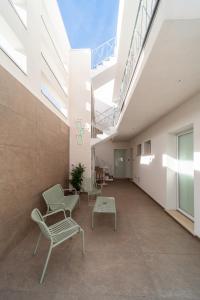 a hallway with chairs and a table in a building at Costamar Vacanze in Lido Marini