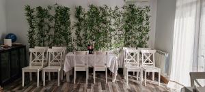 a dining room with a table and chairs and a plant wall at Pensiunea Terra Serenity in Snagov