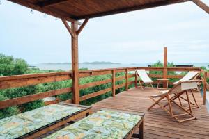 a wooden deck with two chairs and a table at House no 1 in Pakoštane