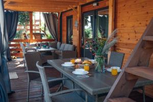 a table and chairs on the porch of a cabin at House no 1 in Pakoštane