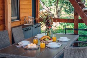 a table with a bowl of fruit and candles on it at House no 1 in Pakoštane