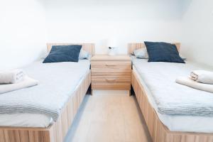 two twin beds sitting next to each other in a room at House no 1 in Pakoštane