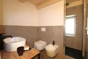 a bathroom with a sink and a toilet at Casa Tomà Mountain View Cortina in San Vito di Cadore +22 photos