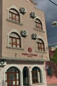 a tall building with windows and a sign on it at PASEO GüEMES HOTEL in Salta