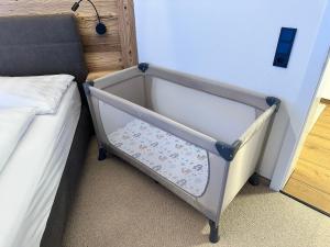 a bed frame with a drawer next to a bed at Klamm Lodge in Weissbach bei Lofer