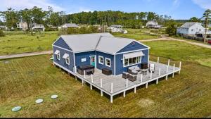 an overhead view of a blue house in a field at Salt & Pine in Mathews, VA in Blackwater