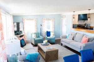 a living room with a couch and chairs and a table at Salt & Pine in Mathews, VA in Blackwater